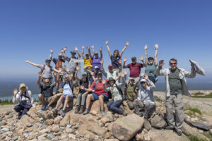 Volunteers pose for a photo on the summit of Sargent Mountain during a soil restoration hike on June 26, 2024 at Sargent Mountain in Mount Desert Island, M.E.