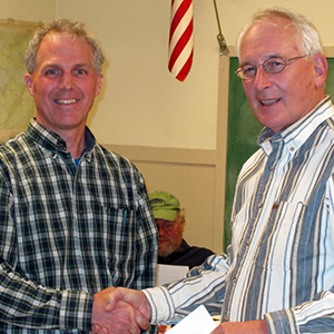 Fred Ehrlenbach, Chairman of the Board of Selectmen (right) and FOA president David MacDonald celebrate the donation of 261 acres to the Town of Trenton.
