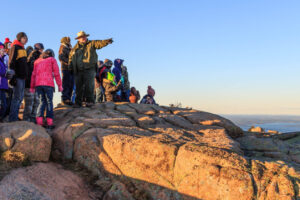 A school group experiences Cadillac Mountain with a park ranger. NPS/Kristi Rugg photo