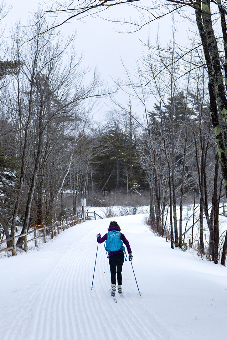  A cross country skier utilizes a freshly groomed Carriage Road around Eagle Lake in Acadia National Park.