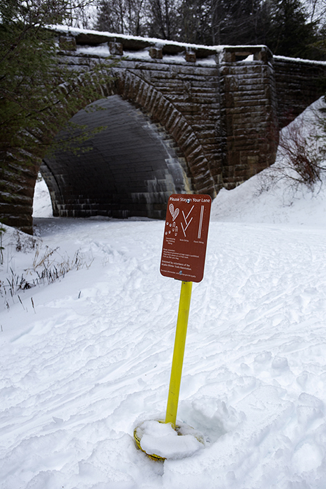 A sign reminds visitors to stay in their lane while enjoying winter recreation on the Carriage Road around Eagle Lake in Acadia National Park. 