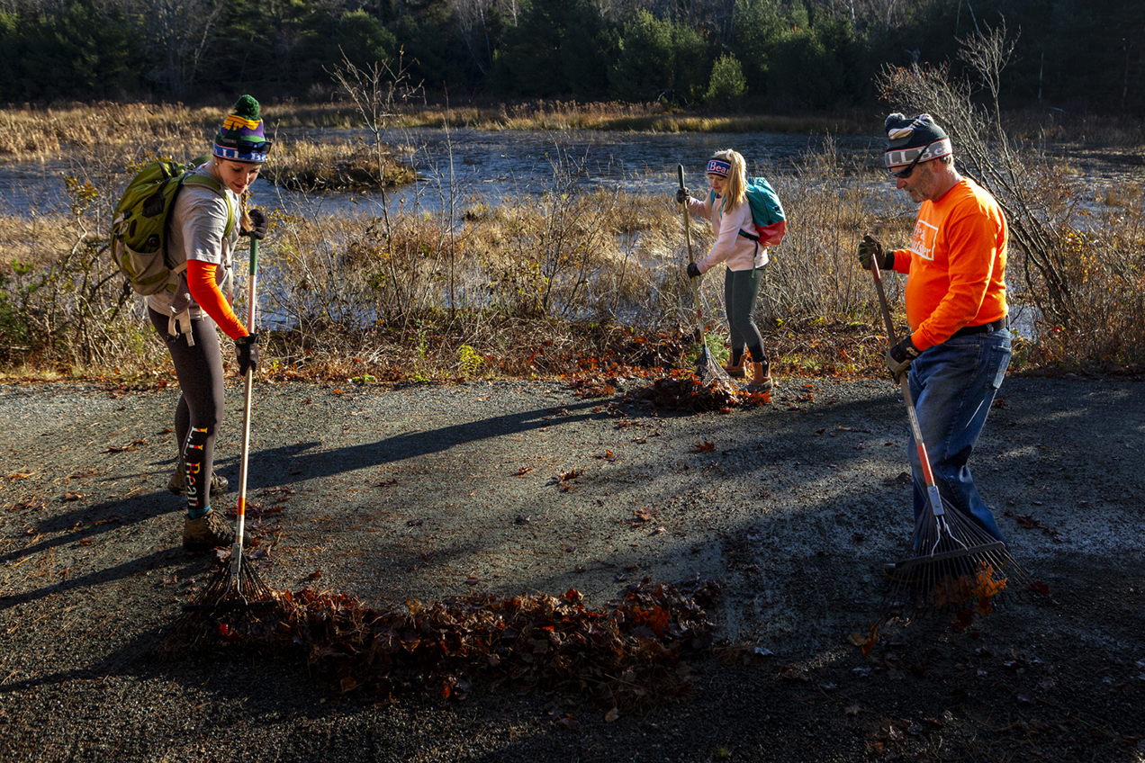 Members of the LL Bean volunteer group work to clear leaves from the carriage road during Friends of Acadia’s annual Take Pride in Acadia Day