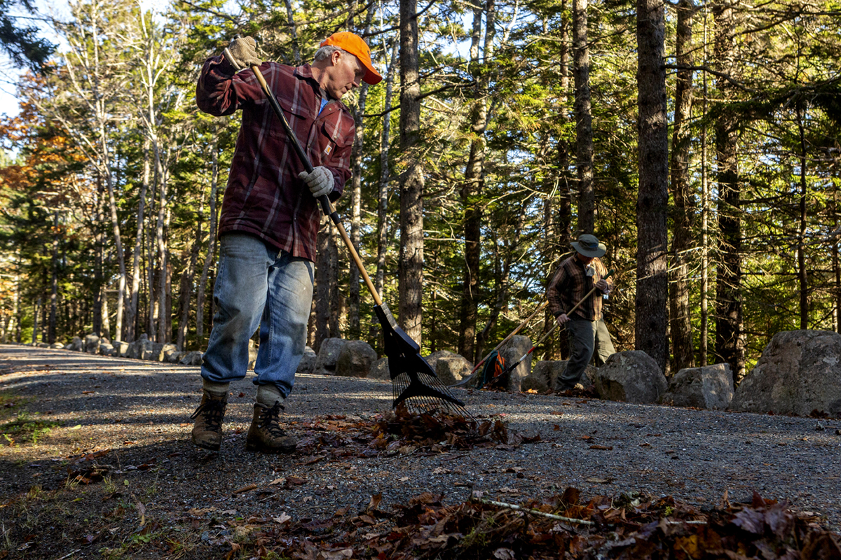 David MacDonald, President and CEO at Friends of Acadia, works to clear leaves off the carriage road as part of the Friends of Acadia volunteer during Friends of Acadia’s annual Take Pride in Acadia Day