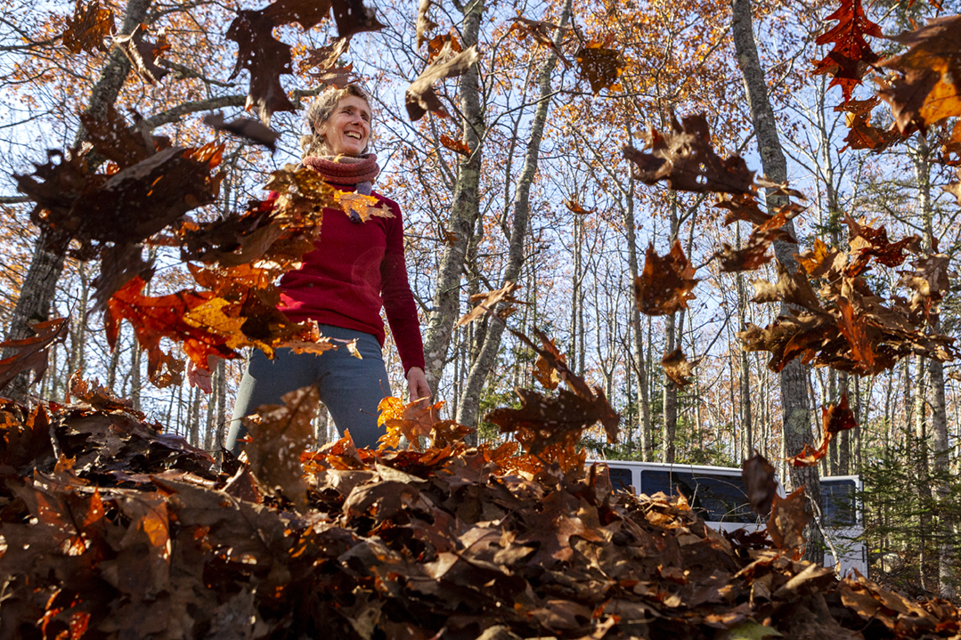 Terese Miller (left) playfully throws leaves at Gary Stellpflug, trails foreman at Acadia National Park, while clearing leaves from the carriage road as part of the Acadia Proud volunteer group during Friends of Acadia’s annual Take Pride in Acadia Day